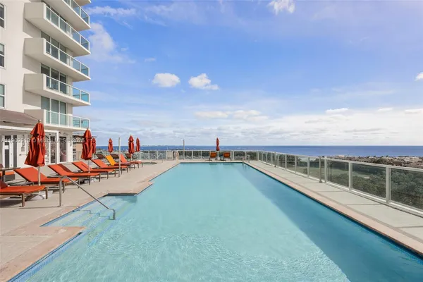 a view of a swimming pool with an outdoor seating