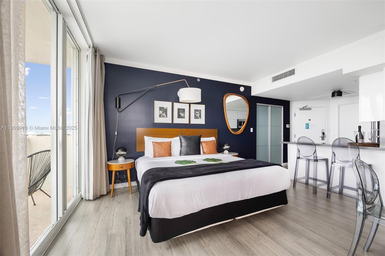 2889 McFarlane Road, Unit 1512 Coconut Grove, FL 33133 - Photo 13 of 25 a bedroom with a bed a mirror and a large window with the outer view