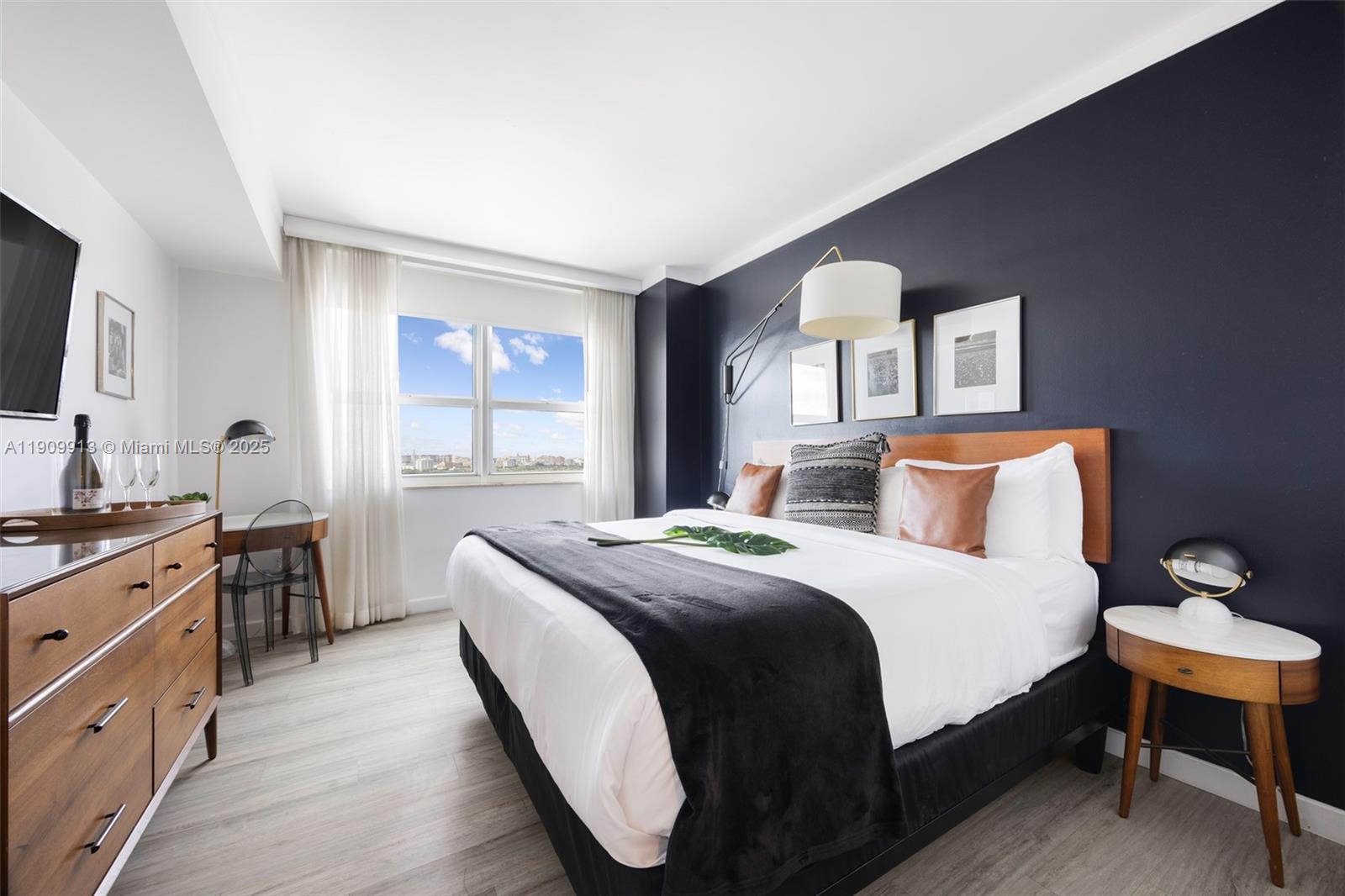 2889 McFarlane Road, Unit 1512 Coconut Grove, FL 33133 - Photo 19 of 25 a bedroom with a bed and a flat screen tv