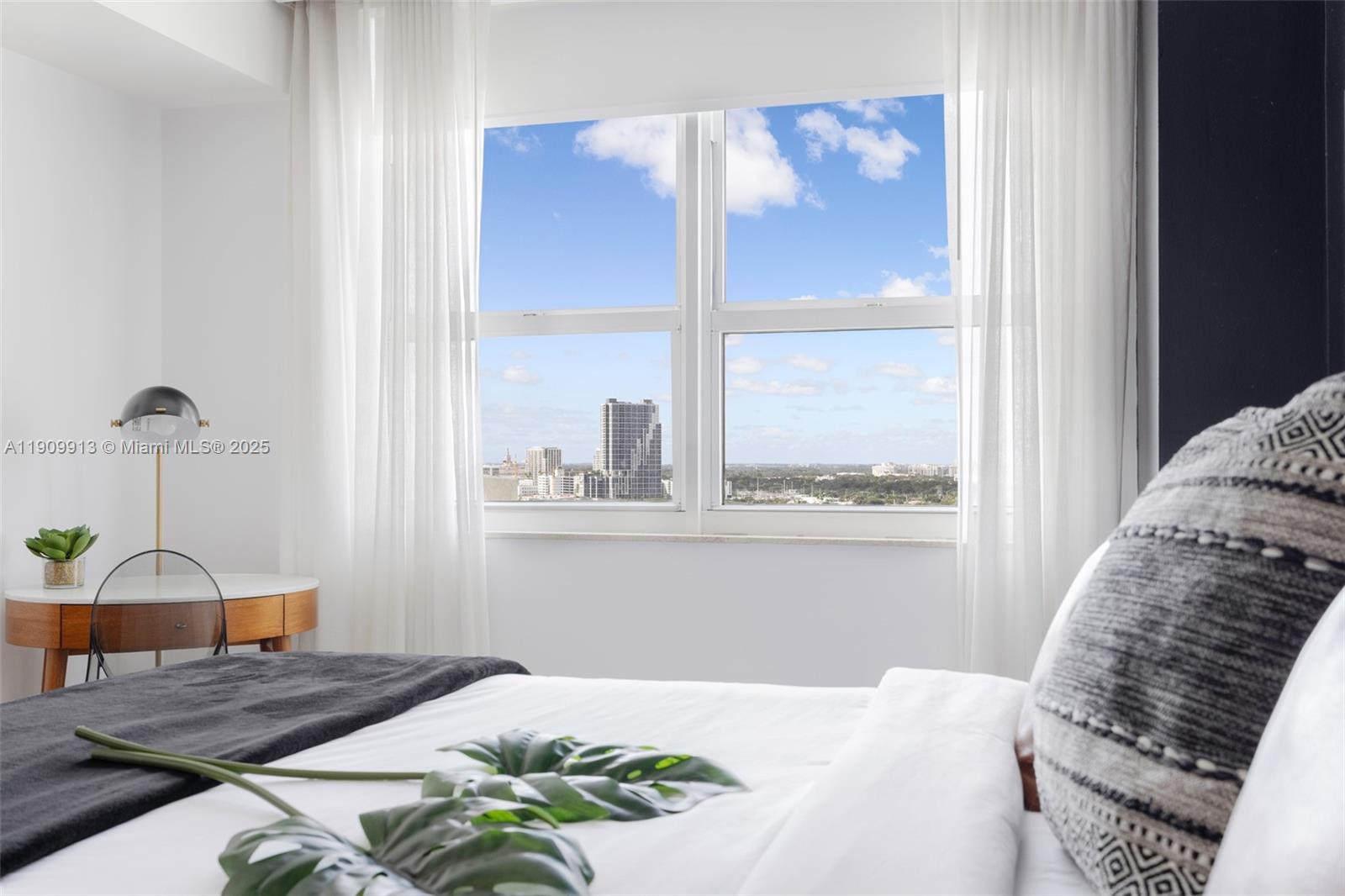 2889 McFarlane Road, Unit 1512 Coconut Grove, FL 33133 - Photo 20 of 25 a bedroom with a bed and window