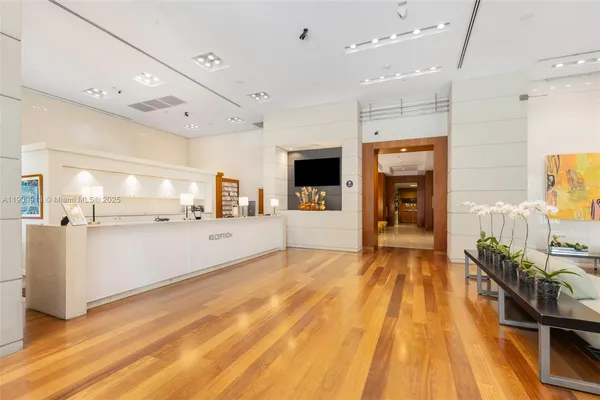 a view of a living room and kitchen with furniture wooden floor and a window