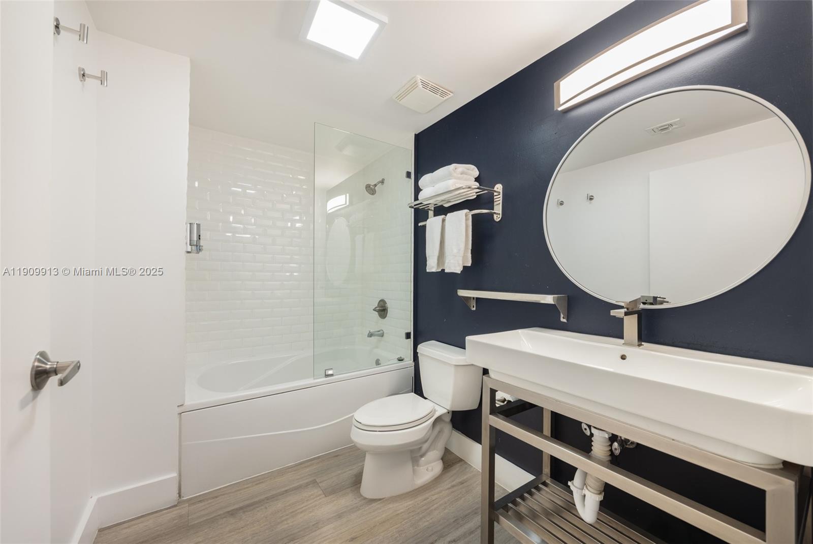 2889 McFarlane Road, Unit 1512 Coconut Grove, FL 33133 - Photo 22 of 25 a bathroom with a toilet a sink and mirror