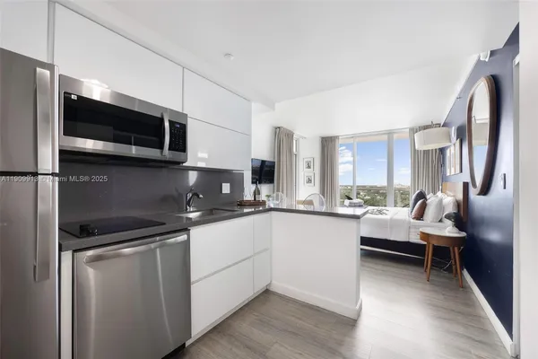 a kitchen with stainless steel appliances granite countertop a sink and microwave