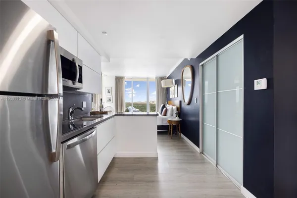 a kitchen with stainless steel appliances a refrigerator stove microwave and sink