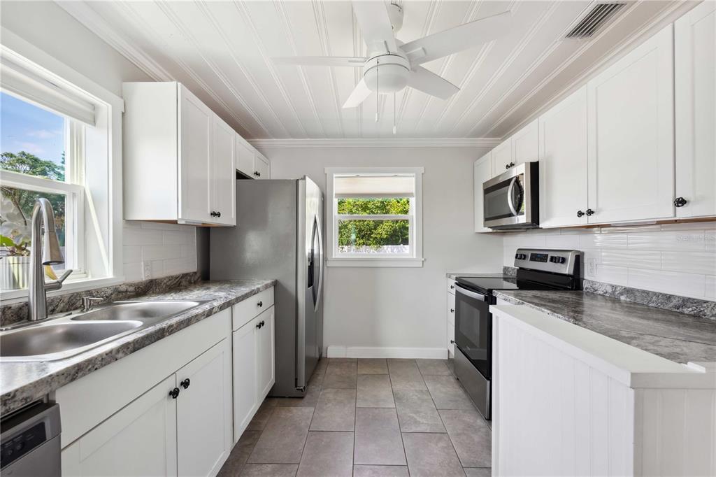113 West Noble Avenue Bushnell, FL 33513 - Photo 12 of 56 a kitchen with a sink stove oven and microwave
