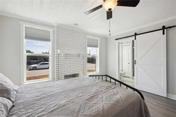 a bedroom with a bed and a window
