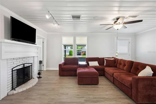 a living room with furniture fireplace and flat screen tv