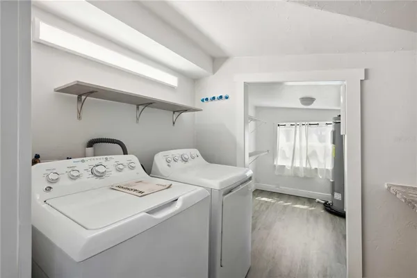 a bathroom with a shower a mirror and a sink