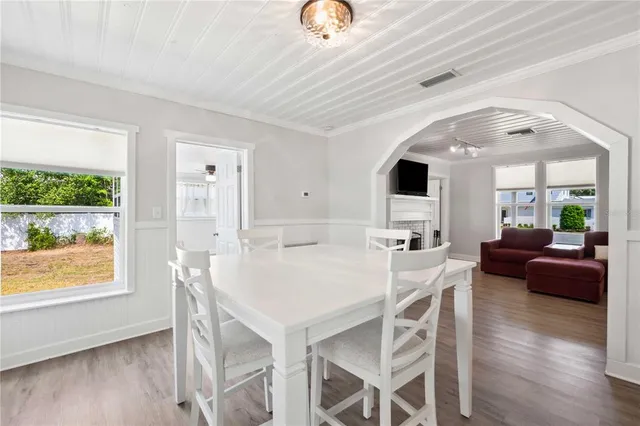 a view of a dining room with furniture and wooden floor