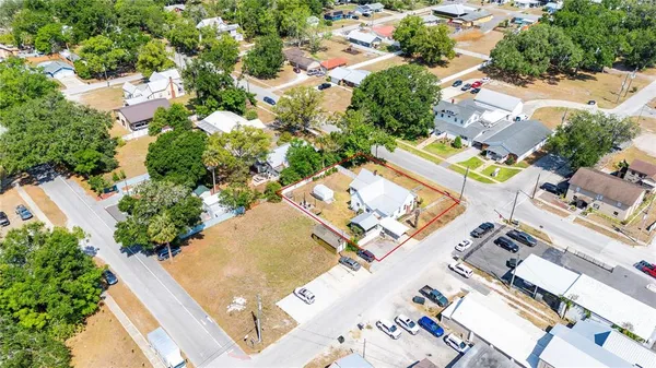 an aerial view of a house with a yard and furniture