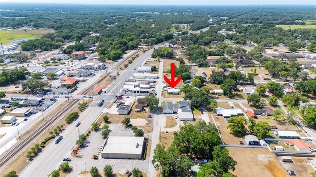 an aerial view of a house with a yard
