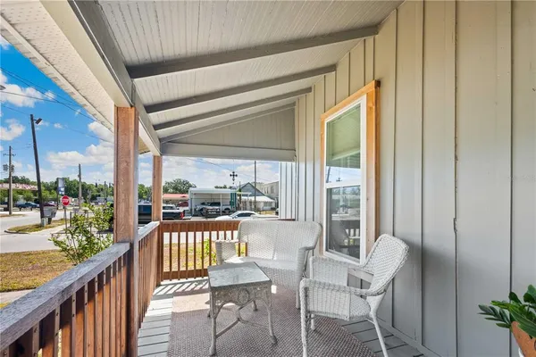 a view of a balcony with furniture
