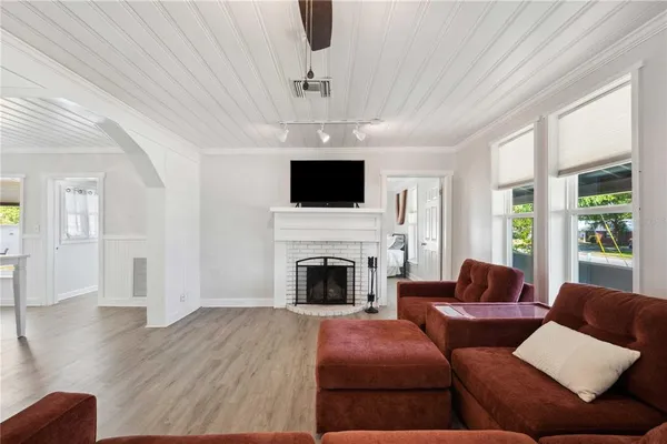 a living room with furniture a fireplace and a flat screen tv