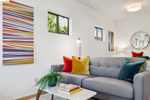 a living room with furniture and a kitchen view