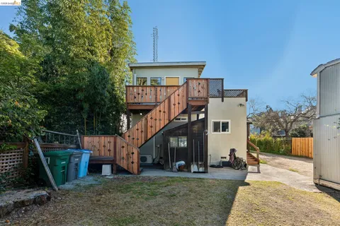a front view of a house with porch and sitting area