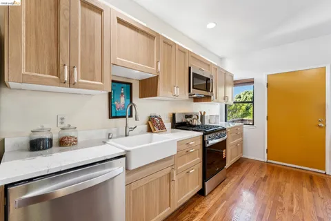 a kitchen with stainless steel appliances a stove a microwave and cabinets