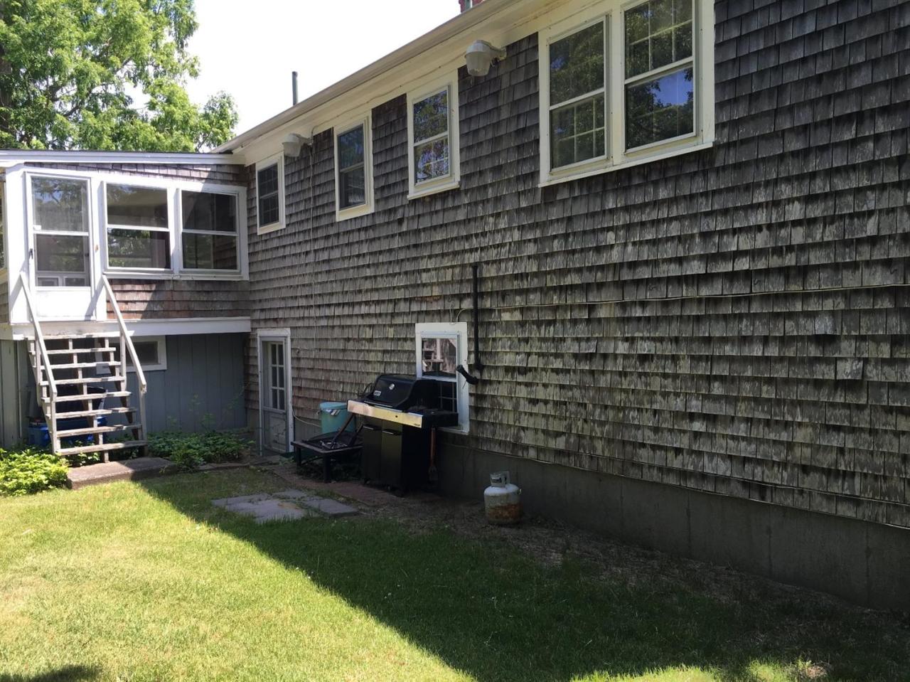 54 Great Marsh Road Centerville, MA 02632 - Photo 13 of 25 a backyard of a house with brick walls