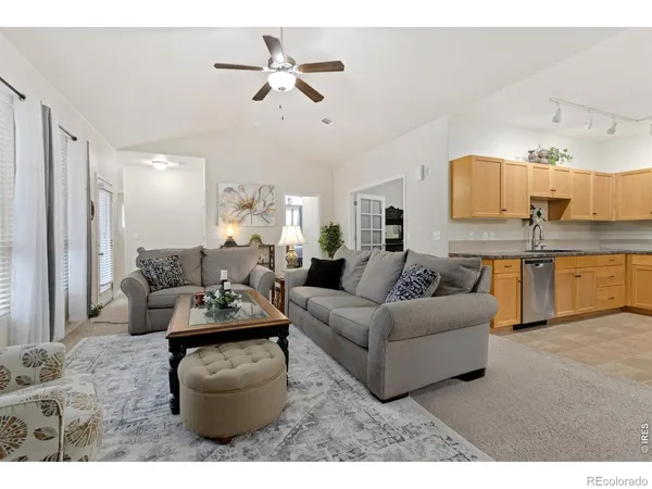 a living room with furniture and kitchen view