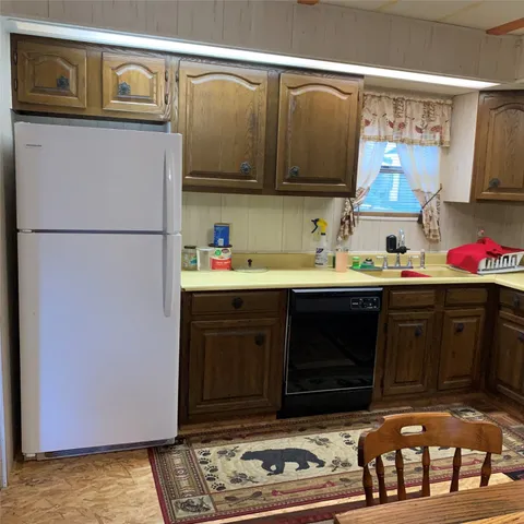 a kitchen with stainless steel appliances granite countertop a refrigerator and a stove