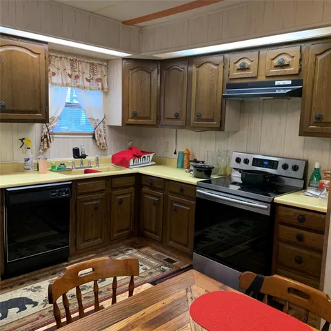 a kitchen with stainless steel appliances a stove a microwave and cabinets