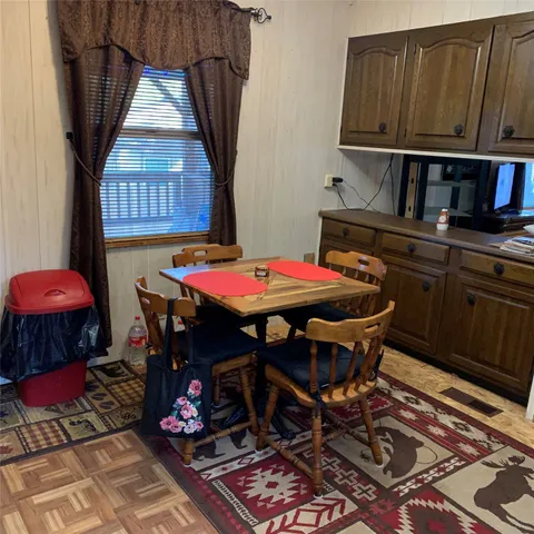 a dining room with furniture and window
