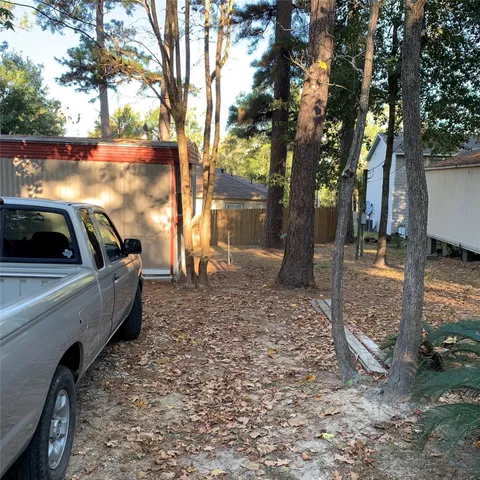 a view of a backyard with large trees