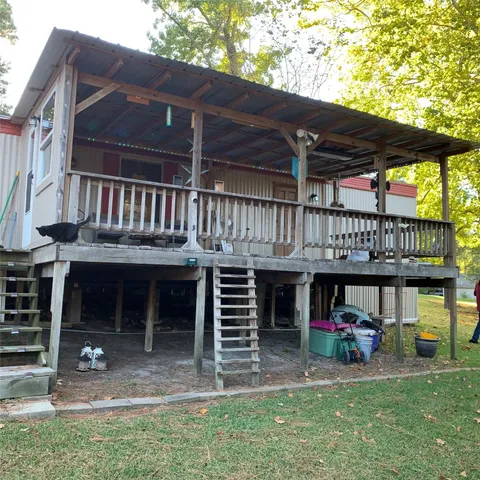 a view of small house with a sink and a yard