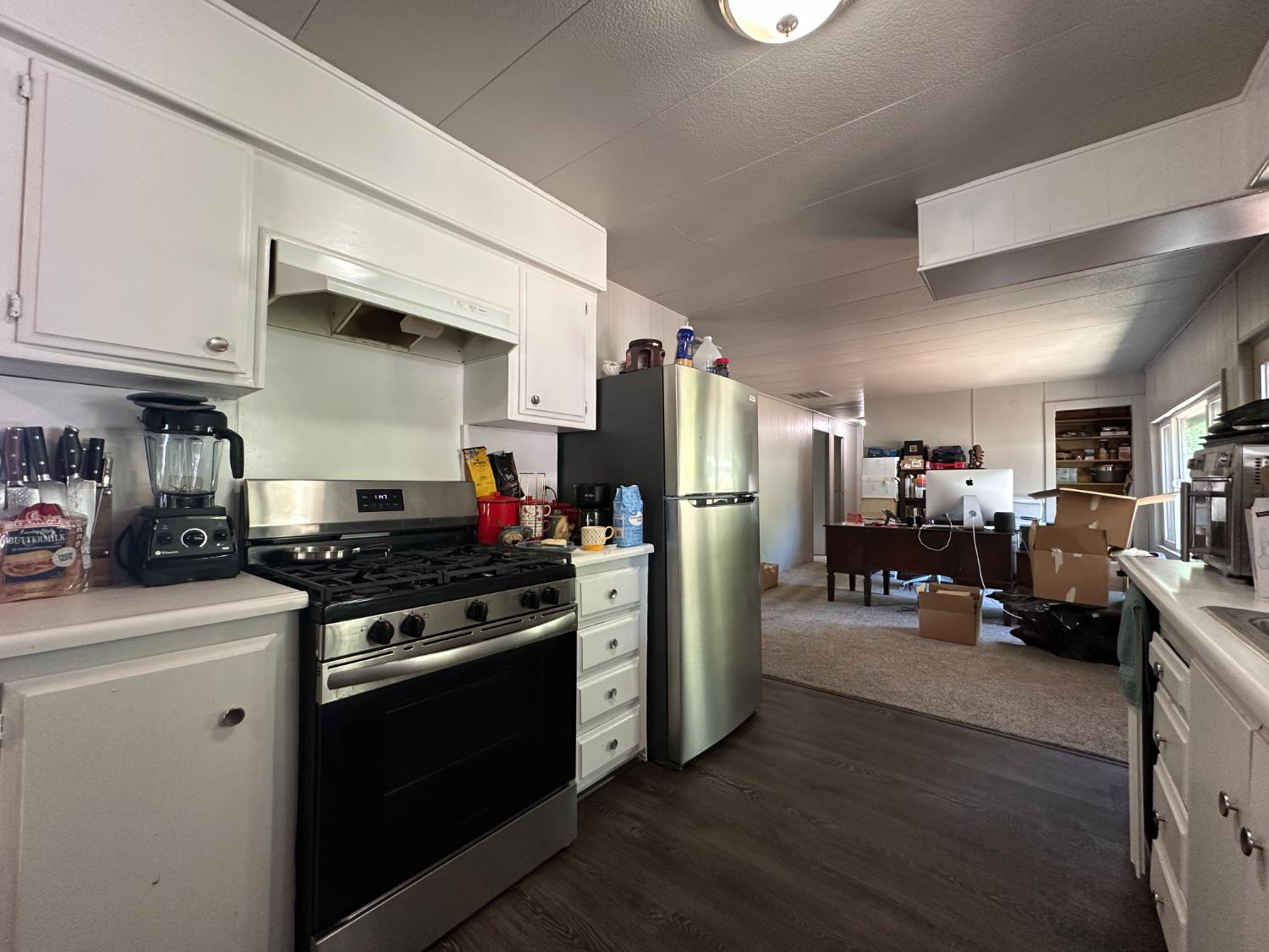 14610 Mono Way, Unit 65 Sonora, CA 95370 - Photo 1 of 24 a kitchen with stainless steel appliances a stove refrigerator and a refrigerator
