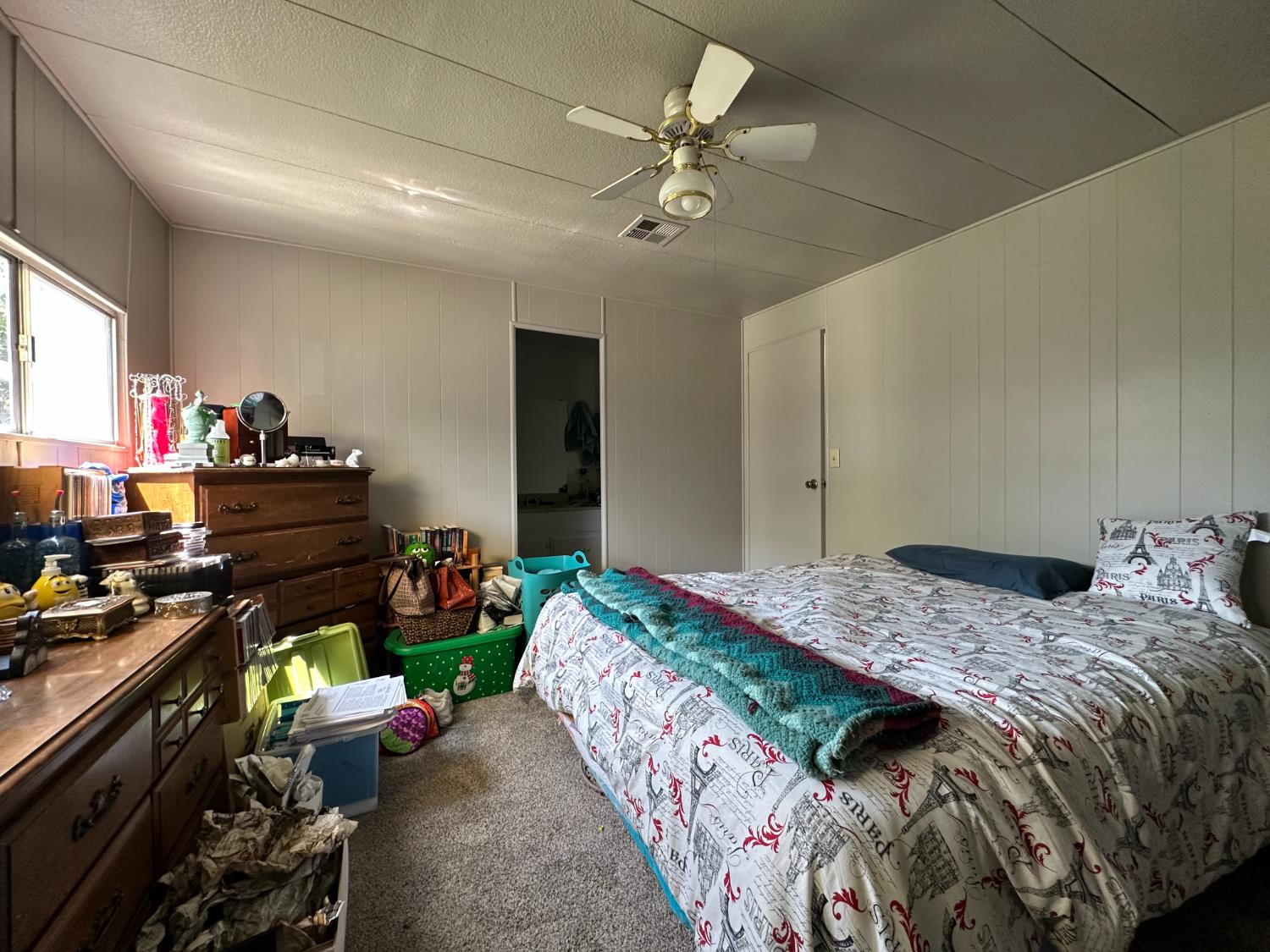 14610 Mono Way, Unit 65 Sonora, CA 95370 - Photo 16 of 24 a bedroom with a bed and a chandelier