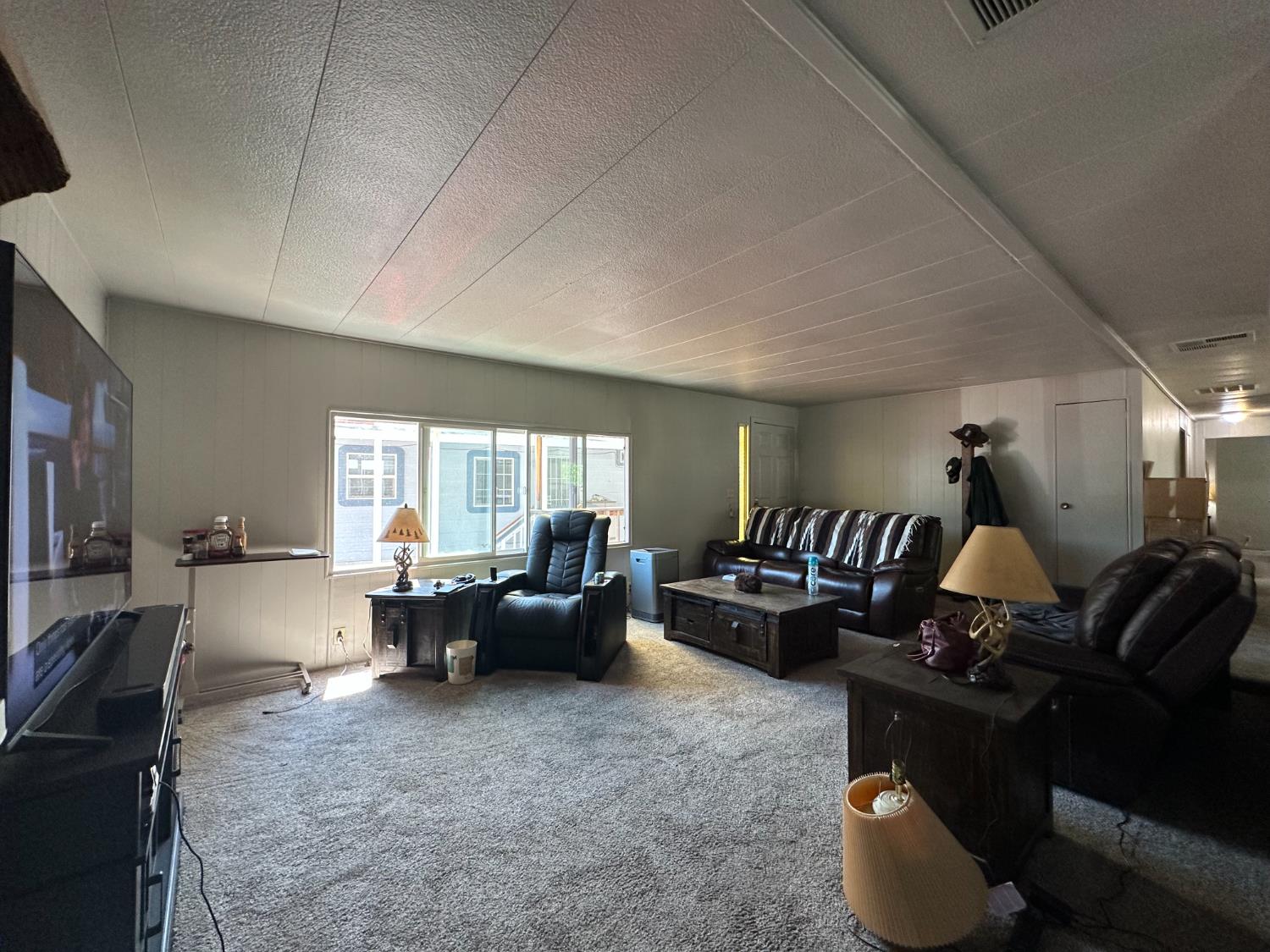 14610 Mono Way, Unit 65 Sonora, CA 95370 - Photo 3 of 24 a living room with furniture and a large window