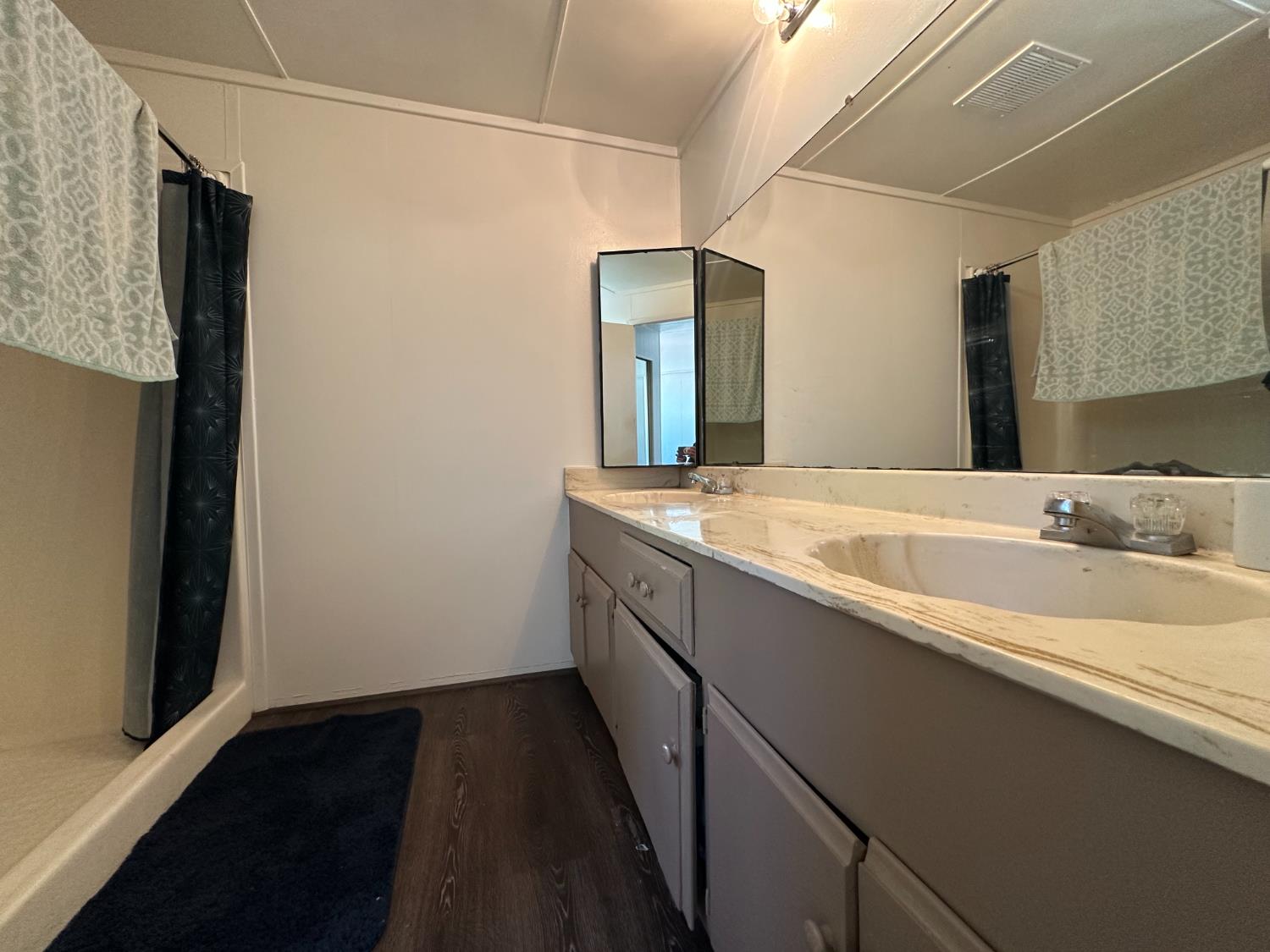 14610 Mono Way, Unit 65 Sonora, CA 95370 - Photo 6 of 24 a bathroom with a double vanity sink and mirror