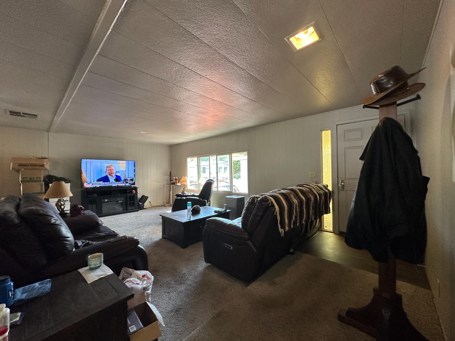 14610 Mono Way, Unit 65 Sonora, CA 95370 - Photo 9 of 24 a living room with furniture and a flat screen tv