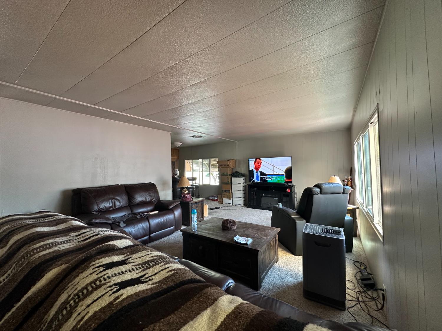 14610 Mono Way, Unit 65 Sonora, CA 95370 - Photo 10 of 24 a living room with furniture and a flat screen tv