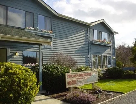 a view of a house with a small yard and plants