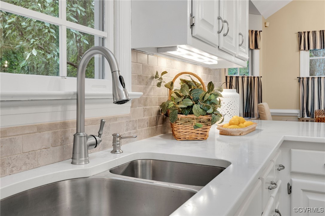 10219 Sioux Road Richmond, VA 23235 - Photo 16 of 48 Details with decorative backsplash, sink, and whit
