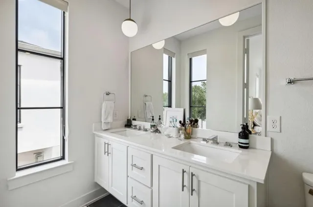 a bathroom with 2 sink and a mirror