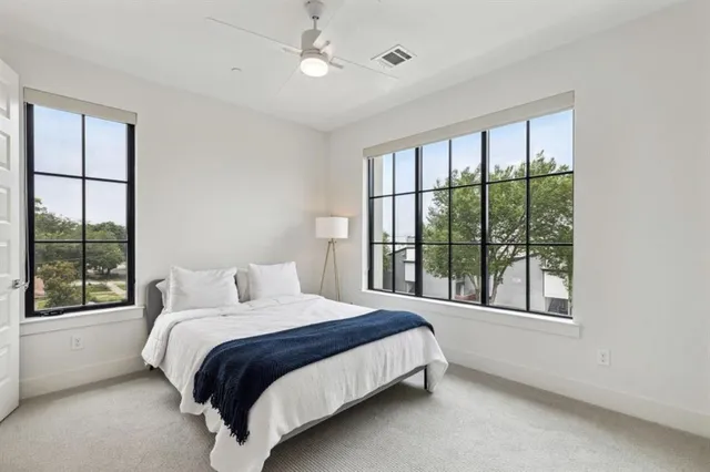 a bedroom with a large bed and a large window