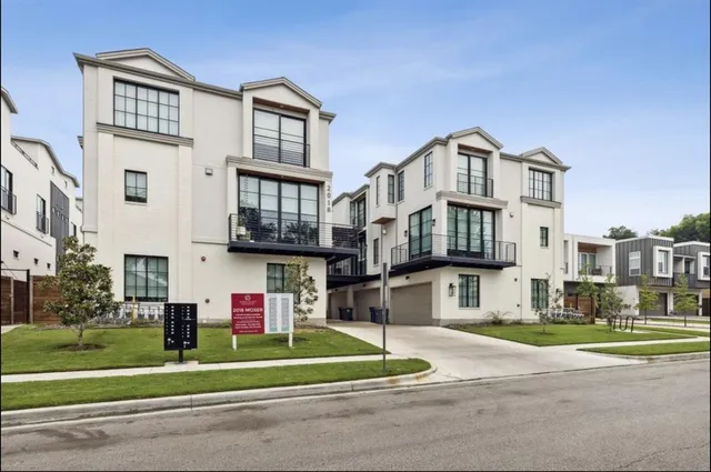 a front view of a residential apartment building with a yard