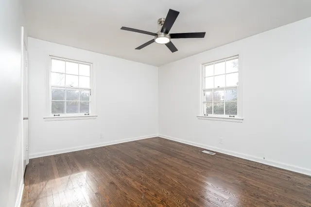 a view of a livingroom with a ceiling fan and window
