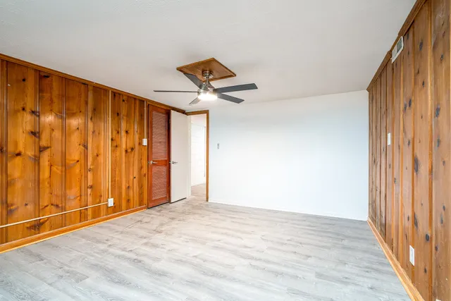 a view of a room with wooden floor