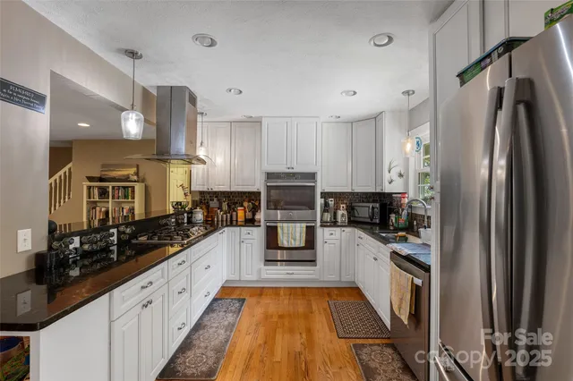 a kitchen with stainless steel appliances a refrigerator sink and cabinets