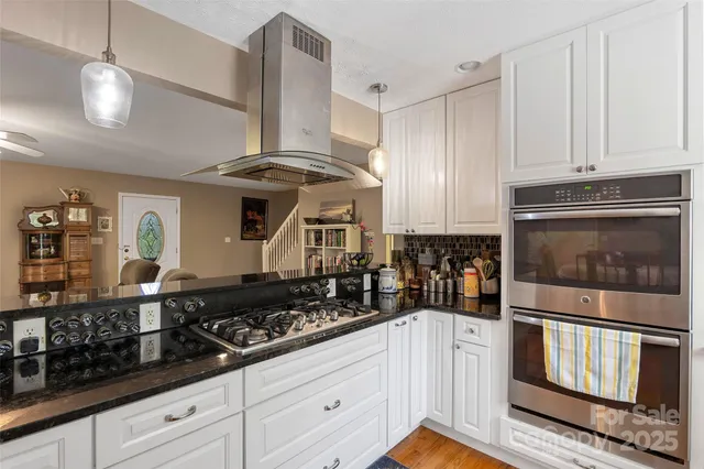 a kitchen with stainless steel appliances a stove a microwave and cabinets