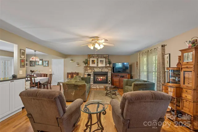 a living room with furniture a fireplace and a chandelier