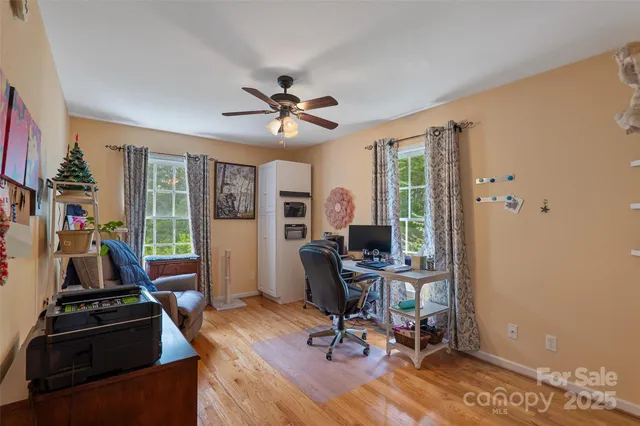 a view of a workspace with furniture and a window