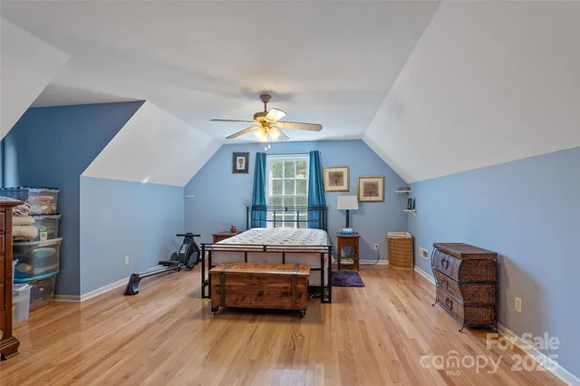 a bedroom with furniture and wooden floor