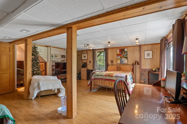 a bedroom with furniture and large window