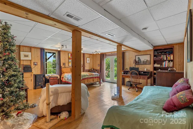 a living room with furniture fireplace and large windows