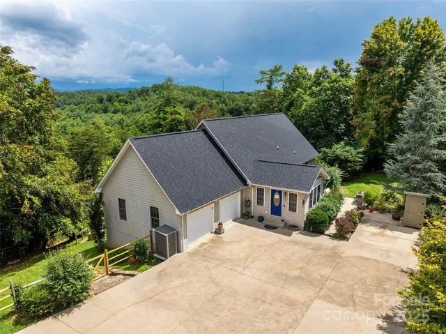 a aerial view of a house with a yard and a garden