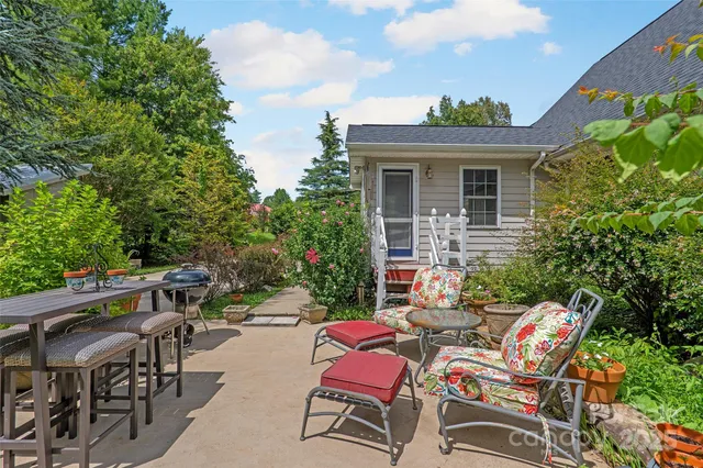 a view of a patio with table and chairs and potted plants