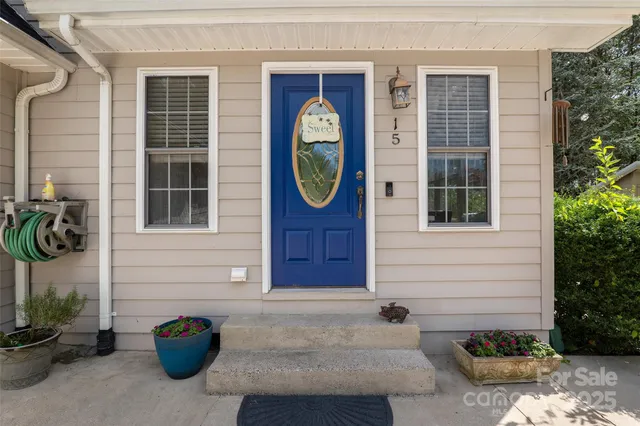 a front view of a house with a potted plant
